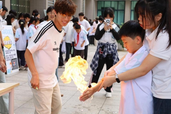 小朋友们在室外广场体验“火焰掌”实验。Beat365官方网站供图